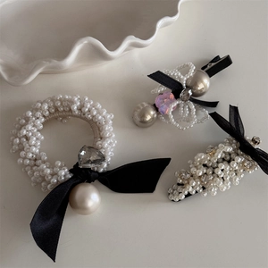 Elegant bow and pearl hair tie set with matching clips for stylish women's hair styling