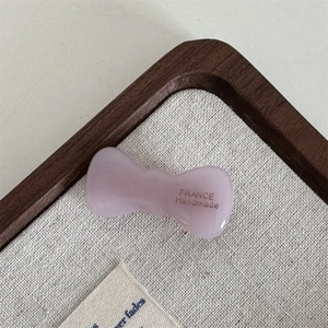 Detail of lavender acetate bow hair clip showing the FRANCE Handmade engraved lettering