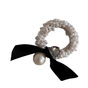 Elegant white pearl scrunchie with black velvet bow and heart crystal detail