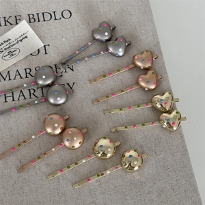 Set of colorful polka dot metal hair clips in heart and round shapes with gold finish