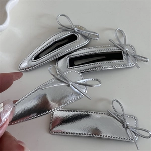 Silver faux leather bow hair clips set featuring teardrop and rectangular metallic designs