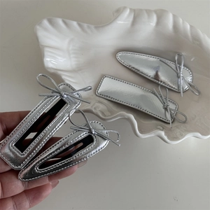 Silver leather bow hair clips set with metallic texture and elegant sewing details