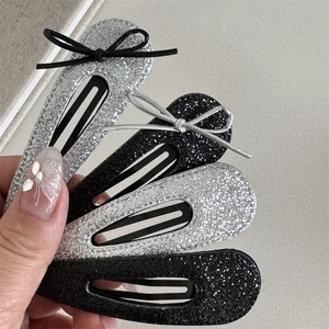 Set of 4 glitter bowknot BB hair clips in silver and black colors for women