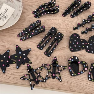 Set of black metal hair clips with colorful polka dots in various geometric shapes