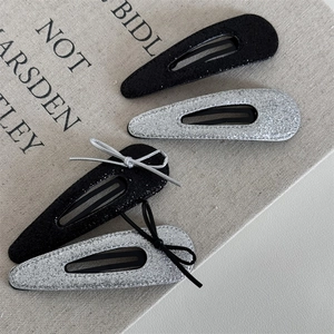 Set of 4 glitter teardrop snap clips in black and silver with elegant ribbon bows