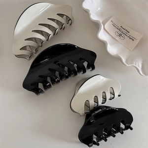 Classic large and small French hair claws in glossy black and cream white finish