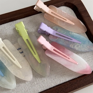Colorful macaron acetate hair clips with marble texture and glitter in a wooden tray