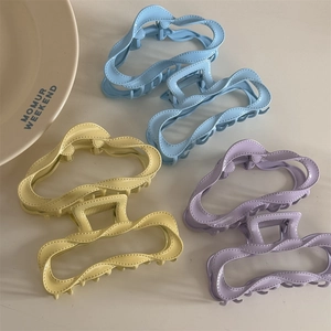 Detail view of large macaron claw clips set featuring a hollow wavy design and matte finish