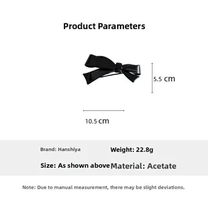 Detail view of black acetate bow hair clip showing 10.5cm dimensions and material info