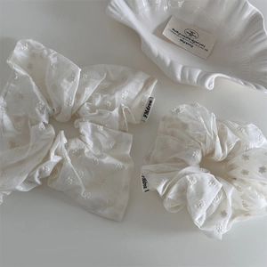 Elegant white embroidered flower hair scrunchies set with a stylish brand label