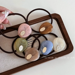 Set of 6 high-elastic hair ties with marble-textured resin charms and gold oval tags