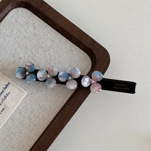 Detailed view of handmade acetate hair clip with colorful gradient resin flowers