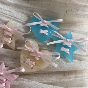 Sweet ballet style cream star and heart hair clips with pink ribbons on soft fabric