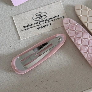 Detail of pink and beige matte plaid hair clips with pearls and metal BB clip structure