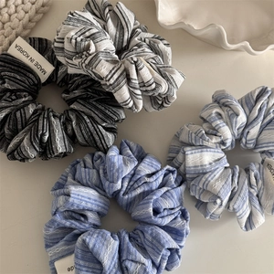 Set of four striped fabric scrunchies in minimalist navy and black sea salt aesthetic