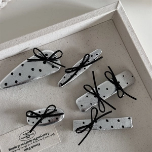 Five-piece silver polka dot leather hair clips with black bows and Y2K aesthetic style