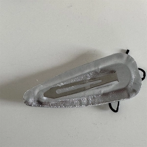 Detailed view of a silver textured metal BB hair clip with a grainy finish and inner band