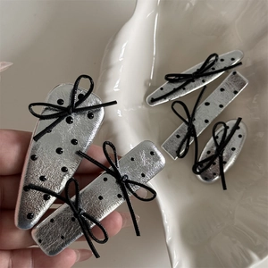 5-piece set of silver metallic hair clips with black polka dots and bows on shell plate