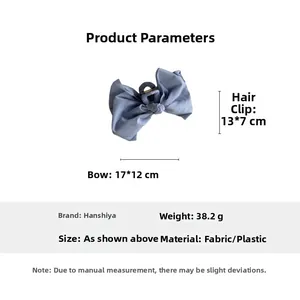 Detail view of large blue fabric bow hair claw clip with specific size measurements