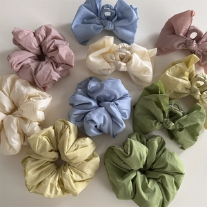 Pastel fabric bow hair claws and oversized scrunchies in assorted soft macaron colors