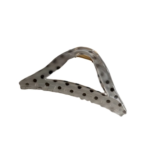 Translucent grey triangle hair claw clip with black polka dots and gold metal spring