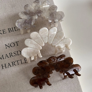 Elegant floral acetate hair claws in marble gray, cream, and amber tones for women