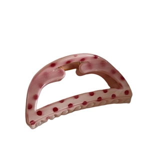 Pink semi-circle hair claw clip with red polka dots for elegant summer hairstyling