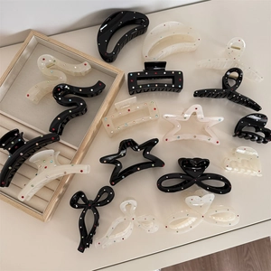 Elegant black and white hair claw clips with colorful rhinestones in butterfly and star shapes