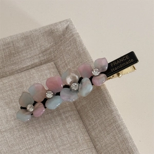 Detailed macro view of the handmade acetate floral hair clip with crystal stamen decoration
