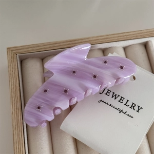 Close-up of lavender marble acetate hair claw clip with purple rhinestones detail