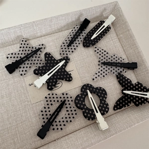 Chic black and white polka dot hair clips in star, flower, and butterfly shapes