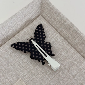 Detail view of the metal duckbill clip back on a retro butterfly hair hairpin