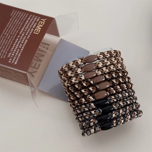 Macro detail of high-elasticity braided hair ties in various colors with a textured finish