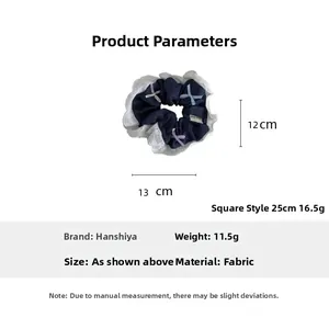 Detailed view of denim hair scrunchie with lace edges and small bow accents