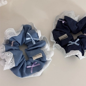 Denim bow hair scrunchies with white lace trim and handmade labels in blue shades