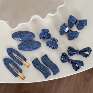 Detailed set of 10 denim patterned hair clips including bows and mini claws on a white tray