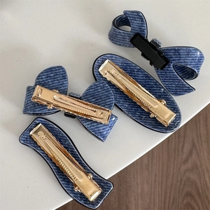 Detailed back view of four-piece denim texture hair clips with metal spring duckbill fasteners