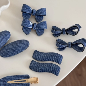 Blue denim pattern hair clip set including bow and wave styles on a cream background