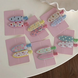 Detail shot of cute floral and polka dot patterns on alligator hair clips set
