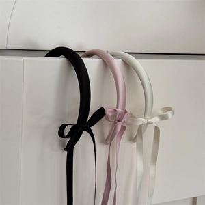 Set of three satin bow headbands with long ribbons in black, pink, and off-white colors