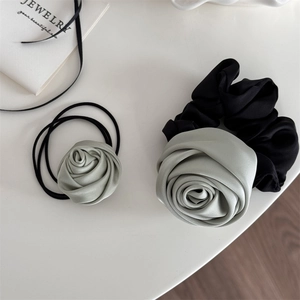 Elegant grey satin rose hair scrunchie set with elastic bands on a white surface