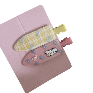 Pair of cute floral duckbill hair clips with cartoon dog and blue bow design for girls