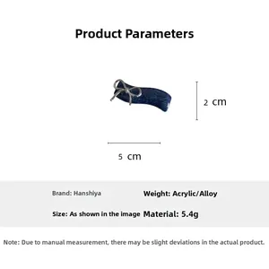 Blue denim texture hair claw with silver metal bow detail and product dimensions
