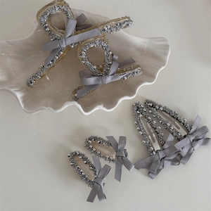 Grey bow hair clip set with silver beads on acrylic claw clips and bobby pins