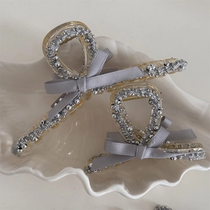 Silver bead grey bow hair claw clips set in shell tray for elegant styling