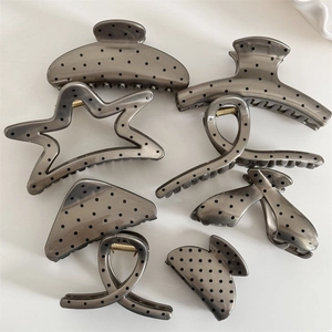 Set of 7 French style dark grey polka dot hair claws in various elegant shapes on white background