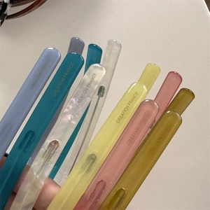 Close-up of colorful acetate hair clips featuring the Creation France engraved text