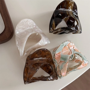 Tortoiseshell acetate hair claw clips in four assorted patterns and glossy finish