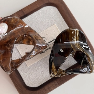 French style acetate tortoise shell and marble hair claw clips set in a tray