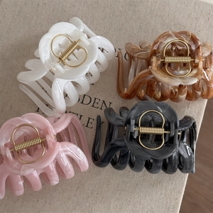Detailed set of four large marble-textured acetate hair claws in neutral colors
